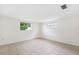 Bright living room featuring tile flooring and two windows offering natural light at 5706 Mockingbird Dr, New Port Richey, FL 34652