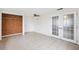 Living room area with tile flooring, French doors and a ceiling fan at 5706 Mockingbird Dr, New Port Richey, FL 34652