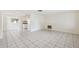 Spacious living room with tile flooring, neutral walls, and natural light from large windows at 5706 Mockingbird Dr, New Port Richey, FL 34652