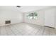 Bright living room showcasing tiled floors and a large window with decorative bars at 5706 Mockingbird Dr, New Port Richey, FL 34652