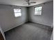 Bedroom features neutral paint, carpet, and multiple windows at 5949 1St Ave, New Port Richey, FL 34652