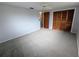 Bedroom with neutral paint, carpet, closet, and a ceiling fan at 5949 1St Ave, New Port Richey, FL 34652