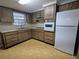 Eat-in kitchen with white appliances and ample cabinet space at 5949 1St Ave, New Port Richey, FL 34652