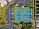 Aerial view of tennis courts next to the canal and boat docks, with parking lot access at 6035 Sea Ranch Dr # 209, Hudson, FL 34667