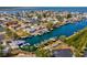 Aerial view shows the neighborhood canal homes, boat docks, and the bay in the distance at 6035 Sea Ranch Dr # 209, Hudson, FL 34667