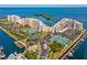 Stunning aerial view of waterfront condos, manicured grounds, tennis courts, and boat docks at 6035 Sea Ranch Dr # 209, Hudson, FL 34667