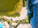 An overhead shot of a condo on a white sand beach, alongside a swimming pool and lush tropical landscaping at 6035 Sea Ranch Dr # 209, Hudson, FL 34667