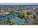 Aerial view of the neighborhood with tennis courts, canal, and docks for boating activities at 6035 Sea Ranch Dr # 209, Hudson, FL 34667