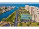 Aerial view of tennis courts, boat docks, the waterway, and the condos showing the location of this property at 6035 Sea Ranch Dr # 209, Hudson, FL 34667