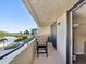 Relaxing balcony view with seating overlooking a beautiful beach and serene bay waters at 6035 Sea Ranch Dr # 209, Hudson, FL 34667