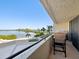 Balcony with seating provides a picturesque view of the water and lush greenery at 6035 Sea Ranch Dr # 209, Hudson, FL 34667