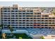 Condo building view featuring private balconies and well-manicured green spaces at 6035 Sea Ranch Dr # 209, Hudson, FL 34667