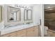 Bathroom vanity with double sinks and marble countertops, plus access to the glass-enclosed shower at 6035 Sea Ranch Dr # 209, Hudson, FL 34667