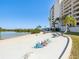 This property has a lovely beach that features colorful lounge chairs and picnic tables for enjoying the waterfront at 6035 Sea Ranch Dr # 209, Hudson, FL 34667