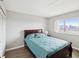 Cozy bedroom features a queen bed, closet, and a bright window with palm tree views at 6035 Sea Ranch Dr # 209, Hudson, FL 34667