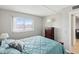 Bright bedroom featuring a comfortable bed, dark wood dresser, and sunny views from the large window at 6035 Sea Ranch Dr # 209, Hudson, FL 34667