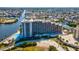 Aerial view of a condo building with stunning waterfront views, a pool, and canal access at 6035 Sea Ranch Dr # 209, Hudson, FL 34667