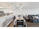 Dining area features modern lighting, wood floors, and complements the adjacent kitchen and living area at 6035 Sea Ranch Dr # 209, Hudson, FL 34667