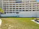 Beautiful condominium property featuring lush green grass, palm trees and tropical landscaping with a clear blue sky at 6035 Sea Ranch Dr # 209, Hudson, FL 34667