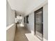 Well-maintained hallway leading to a unit, featuring textured walls and exterior windows at 6035 Sea Ranch Dr # 209, Hudson, FL 34667