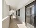 Exterior hallway leading to a unit featuring an 'Exit' sign and black framed door at 6035 Sea Ranch Dr # 209, Hudson, FL 34667