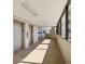 Bright hallway with elevators and windows offering natural light at 6035 Sea Ranch Dr # 209, Hudson, FL 34667
