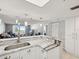 Bright kitchen featuring marble countertops, stainless steel sink and white cabinetry with eat in breakfast bar at 6035 Sea Ranch Dr # 209, Hudson, FL 34667
