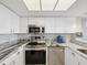 Well-equipped kitchen with stainless steel appliances and stylish countertops at 6035 Sea Ranch Dr # 209, Hudson, FL 34667