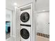 Convenient laundry closet with a stacked washer and dryer unit at 6035 Sea Ranch Dr # 209, Hudson, FL 34667