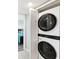 A laundry area with an LG stackable washer and dryer unit behind white louvered doors at 6035 Sea Ranch Dr # 209, Hudson, FL 34667