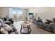 Inviting living room showcasing wood floors, a sliding door to the balcony, and ample natural light at 6035 Sea Ranch Dr # 209, Hudson, FL 34667