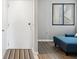 Entrance to living room with stylish door, flooring, and comfortable blue sofa at 6035 Sea Ranch Dr # 209, Hudson, FL 34667