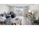 Spacious living room featuring wood floors, access to the balcony, and offers plenty of seating at 6035 Sea Ranch Dr # 209, Hudson, FL 34667