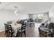 Bright living room with wood floors, modern lighting, and a sliding door to private balcony at 6035 Sea Ranch Dr # 209, Hudson, FL 34667