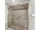 Contemporary bathroom featuring a glass-enclosed tiled shower with a showerhead and safety bars at 6035 Sea Ranch Dr # 209, Hudson, FL 34667