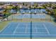 Aerial view of well-maintained tennis courts perfect for recreational play at 6035 Sea Ranch Dr # 209, Hudson, FL 34667