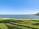 Scenic waterfront with lush lawn area and views of the tranquil water at 6035 Sea Ranch Dr # 209, Hudson, FL 34667