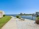 Scenic waterfront property with lush landscaping, a tranquil walkway, and a stunning view of the calm bay at 6035 Sea Ranch Dr # 209, Hudson, FL 34667