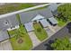Aerial shot showcasing the home's landscaped yard, carport, and proximity to nearby properties in the neighborhood at 6047 Elmhurst Dr # 5A, New Port Richey, FL 34653