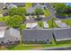 An aerial view of the home showcasing the nearby amenities like a pool and tennis court at 6047 Elmhurst Dr # 5A, New Port Richey, FL 34653