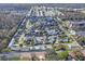 Expansive aerial view of a well-maintained neighborhood featuring charming homes and tranquil waterways throughout the community at 6047 Elmhurst Dr # 5A, New Port Richey, FL 34653
