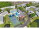 Aerial view of the community's pool, tennis court, pond and surrounding homes at 6047 Elmhurst Dr # 5A, New Port Richey, FL 34653