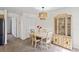 Charming dining room with a china cabinet for displaying your favorite dishes at 6047 Elmhurst Dr # 5A, New Port Richey, FL 34653