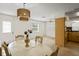 Open-concept dining room with a large table and views of the adjoining living areas at 6047 Elmhurst Dr # 5A, New Port Richey, FL 34653