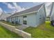Back exterior of house with AC units, patio, block fence, and grassy lawn at 6047 Elmhurst Dr # 5A, New Port Richey, FL 34653