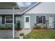 Inviting front entrance with decorative door, manicured flowerbeds, and a welcoming walkway to the home at 6047 Elmhurst Dr # 5A, New Port Richey, FL 34653