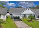 Exterior view featuring a well-kept front lawn, carport, and inviting landscaping at 6047 Elmhurst Dr # 5A, New Port Richey, FL 34653