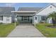 Charming single-story home featuring a covered parking area and well-maintained landscaping at 6047 Elmhurst Dr # 5A, New Port Richey, FL 34653