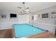 A well-lit game room features a pool table with overhead lighting and wall decor at 6047 Elmhurst Dr # 5A, New Port Richey, FL 34653