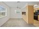 Bright living room boasts plush carpet, a ceiling fan, and an adjacent snack bar to the kitchen at 6047 Elmhurst Dr # 5A, New Port Richey, FL 34653